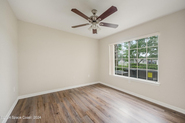 unfurnished room with ceiling fan and hardwood / wood-style flooring