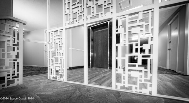 interior space featuring elevator and wood-type flooring