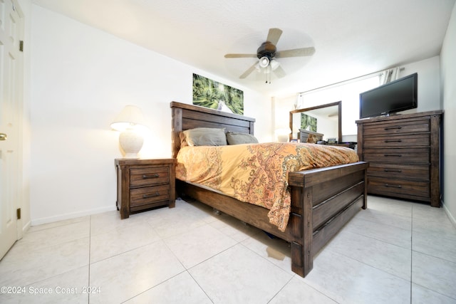 tiled bedroom featuring ceiling fan