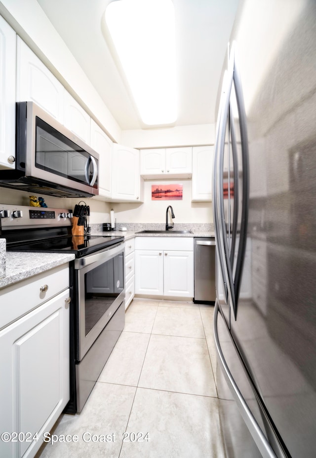 kitchen with white cabinetry, sink, and stainless steel appliances