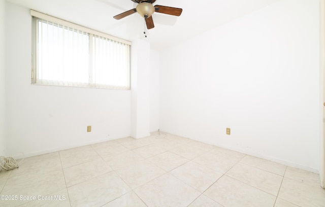 empty room with light tile patterned floors and ceiling fan