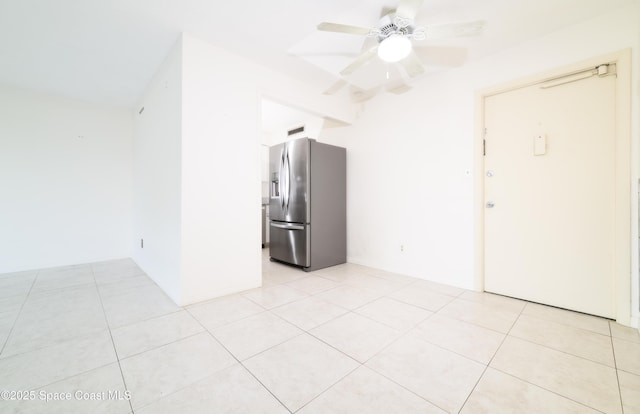 empty room featuring light tile patterned flooring and ceiling fan