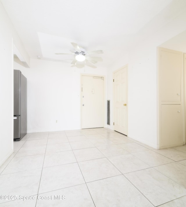 empty room with light tile patterned floors and ceiling fan