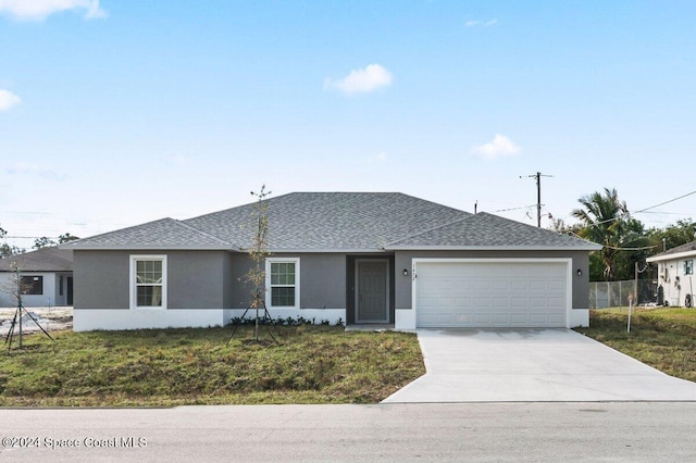 single story home with a front yard and a garage