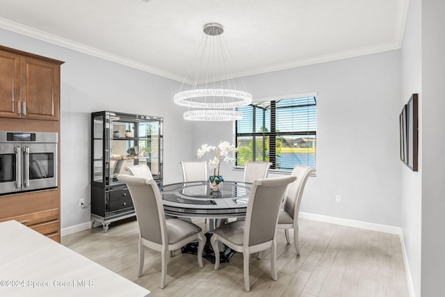 dining space with plenty of natural light, a chandelier, and light wood-type flooring