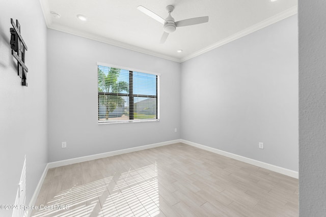 empty room with ceiling fan, light wood-type flooring, and crown molding