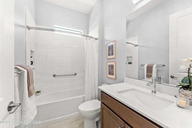 full bathroom featuring hardwood / wood-style floors, vanity, shower / tub combo, and toilet