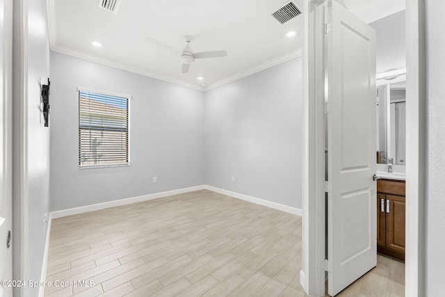 empty room with ceiling fan, light hardwood / wood-style floors, and ornamental molding