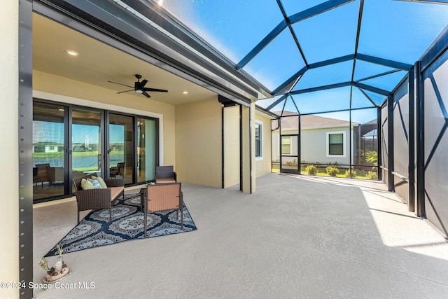 view of patio featuring a lanai and ceiling fan