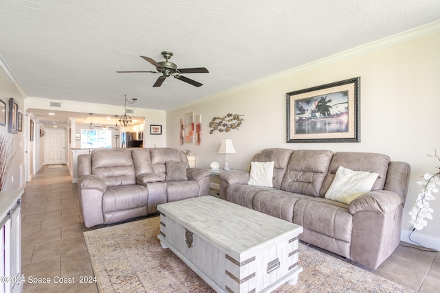 living room with a textured ceiling, ornamental molding, and ceiling fan