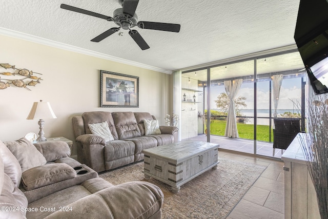 tiled living room featuring ceiling fan, a textured ceiling, crown molding, and floor to ceiling windows