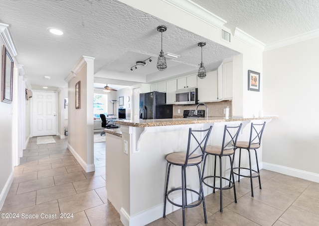 kitchen with a textured ceiling, white cabinets, kitchen peninsula, black fridge with ice dispenser, and ornamental molding