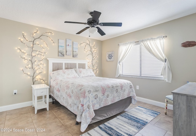 tiled bedroom featuring ceiling fan