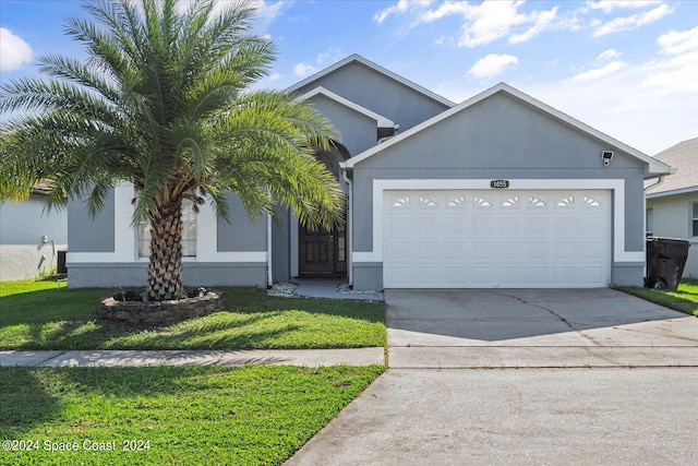 view of front of home with a garage and a front yard