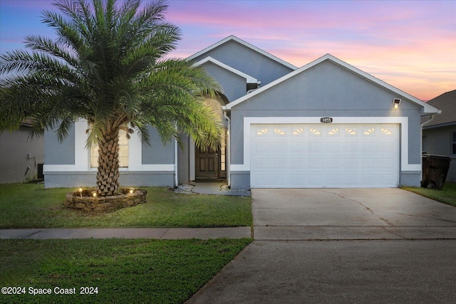 view of front of home featuring a yard and a garage