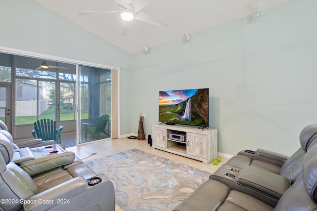 tiled living room with ceiling fan and high vaulted ceiling