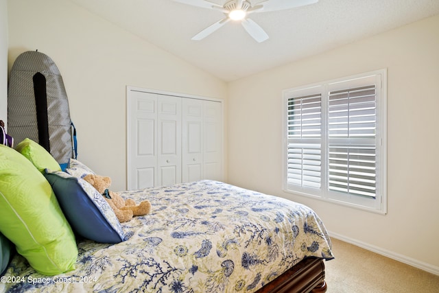 bedroom featuring ceiling fan, carpet floors, a closet, and lofted ceiling