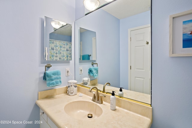 bathroom with vanity and a textured ceiling