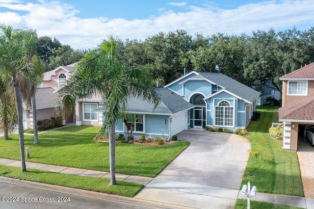 view of front of property with a garage and a front lawn