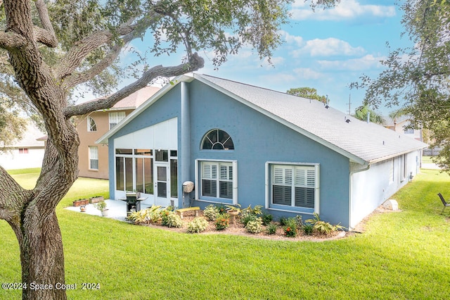 view of front of property featuring a front lawn and a sunroom