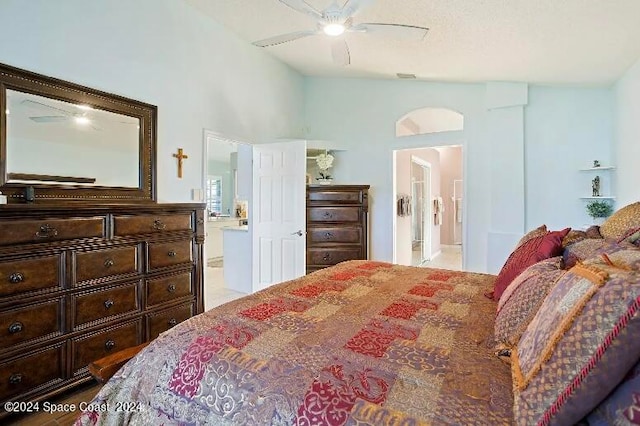 bedroom featuring vaulted ceiling, ceiling fan, and ensuite bathroom