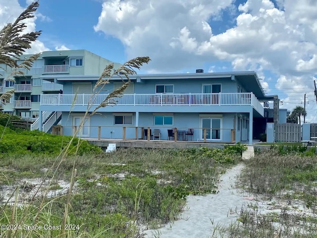 back of house featuring a balcony