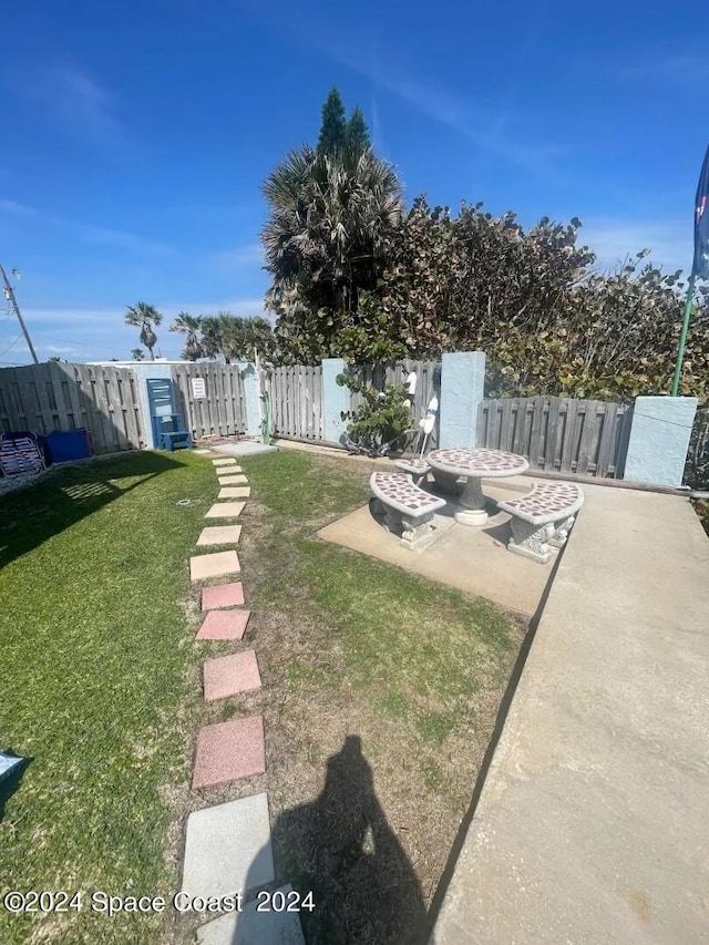 view of yard with a patio and an outdoor fire pit