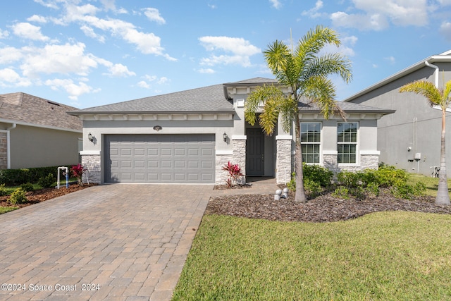 view of front of house with a garage and a front yard