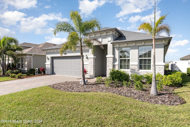 view of front of house featuring a garage and a front yard