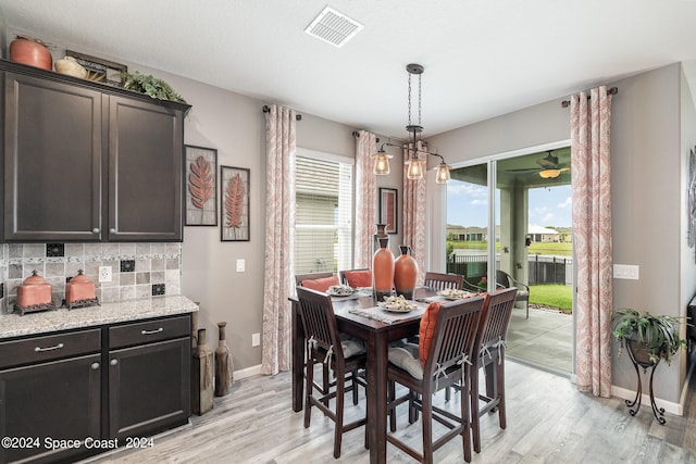 dining space with light hardwood / wood-style floors