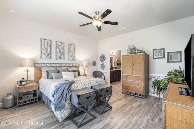 bedroom featuring ceiling fan, hardwood / wood-style flooring, and ensuite bathroom