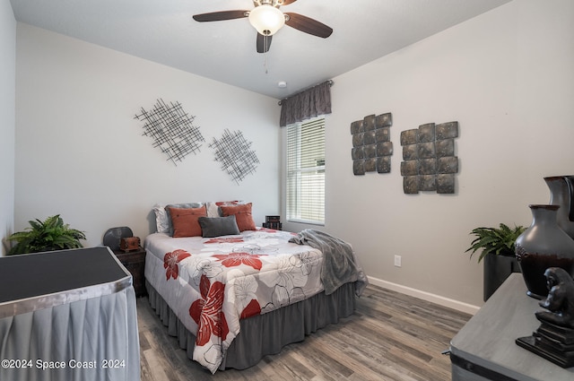 bedroom featuring ceiling fan and dark wood-type flooring