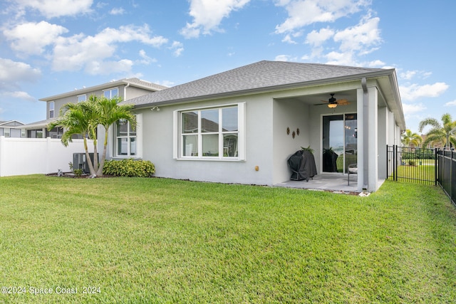 rear view of house with a lawn, ceiling fan, a patio area, and central air condition unit