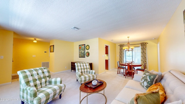 living room featuring light colored carpet, a textured ceiling, and a chandelier