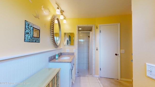 bathroom with tile patterned flooring, a shower with door, and vanity