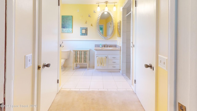 bathroom with tile patterned flooring, vanity, and toilet