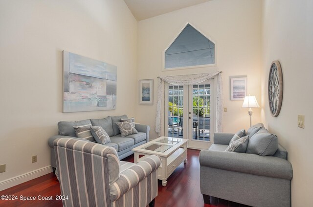 living room with french doors, a high ceiling, and dark wood-type flooring