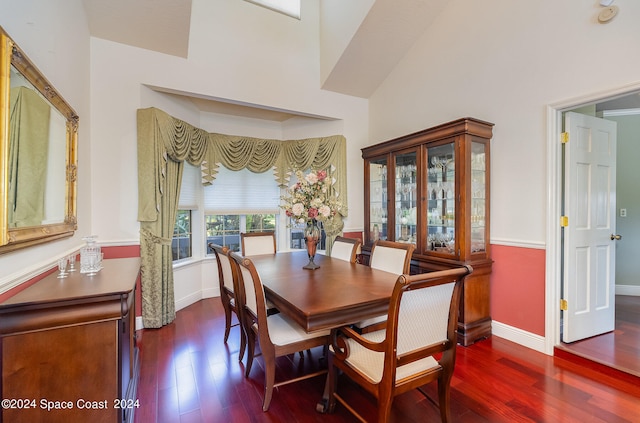 dining area with hardwood / wood-style flooring and high vaulted ceiling