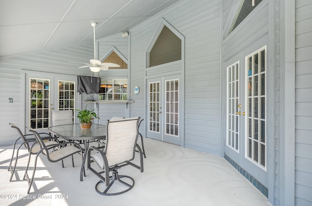 sunroom featuring lofted ceiling, ceiling fan, and french doors