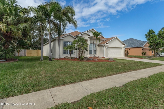 view of front of property with a front lawn and a garage