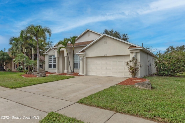 view of front of home with a front lawn and a garage