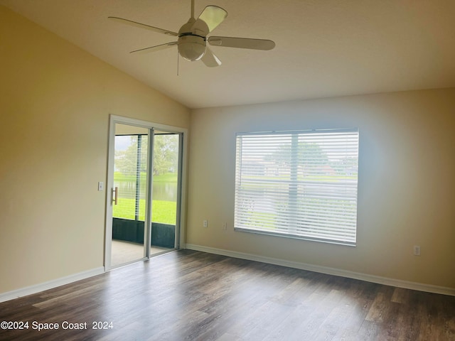 unfurnished room featuring a wealth of natural light, lofted ceiling, ceiling fan, and hardwood / wood-style flooring