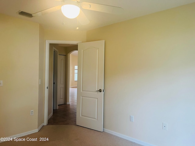 spare room with ceiling fan and carpet flooring