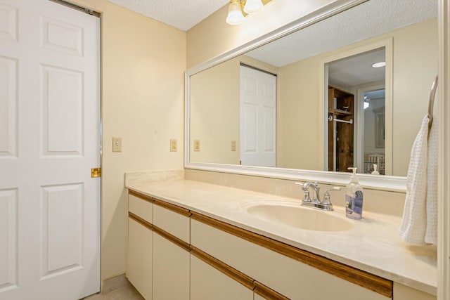 bathroom with vanity and a textured ceiling