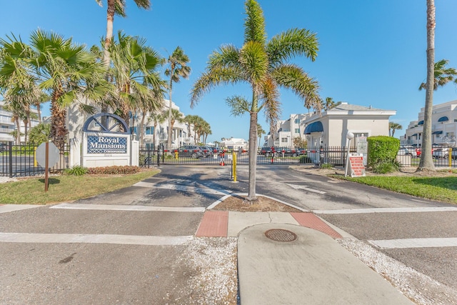 view of street featuring a gated entry, a gate, and traffic signs