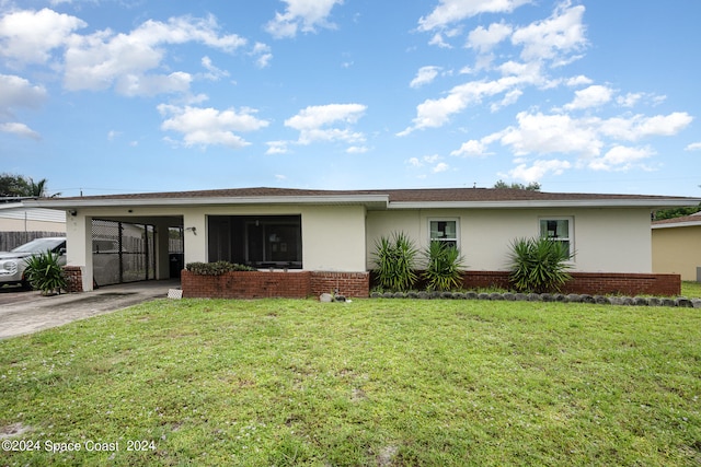 ranch-style house featuring a front lawn and a carport