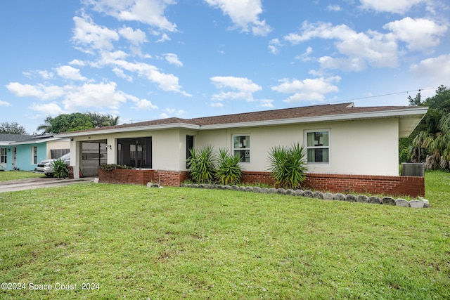 ranch-style house featuring a front lawn and a garage