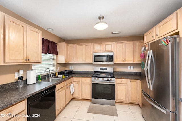 kitchen featuring light brown cabinets, appliances with stainless steel finishes, light tile patterned flooring, and sink