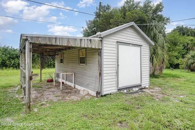 view of outdoor structure featuring a lawn