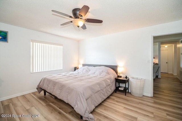 bedroom with ceiling fan and light hardwood / wood-style flooring